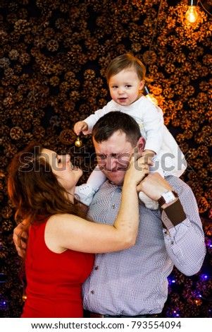 Happy family with a baby smiling at the camera