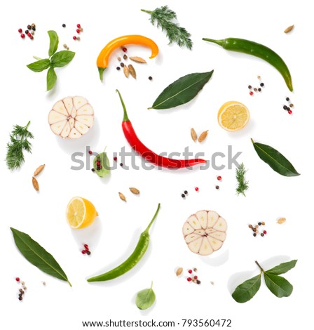 Top view of various herbs and spices ( pepper, basil, cardamom, bay leaf, garlic, lemon, dill and chilli ) isolated on white background. 