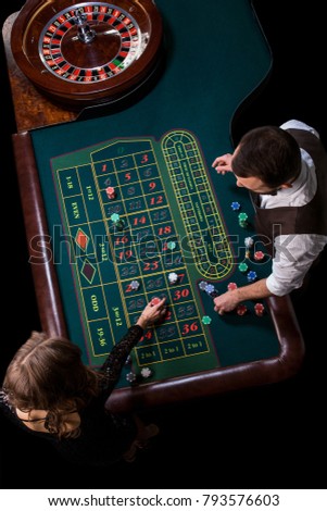 Croupier and woman player at a table in a casino. Picture of a c