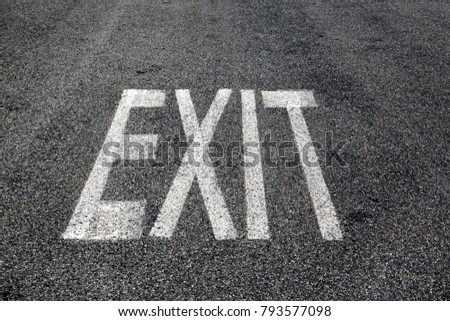 Exit sign painted on asphalt surface