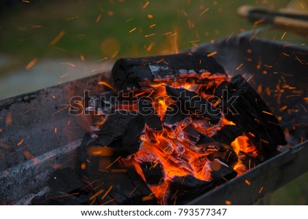 Fire charcoal in stove for cooking and grilling food or barbecue. Royalty-Free Stock Photo #793577347