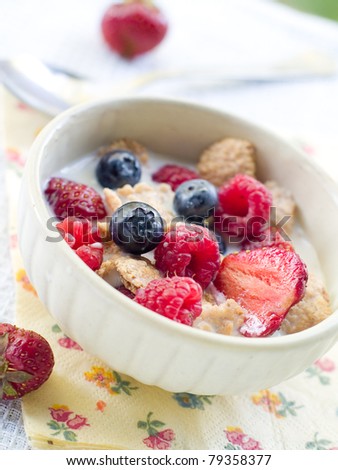 Oat flakes with berries and milk for breakfast. Selective focus