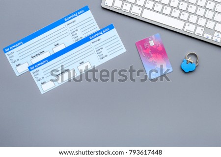 Planning journey and buy tickets. Documents near bank card and keyboard on grey background top view copy space