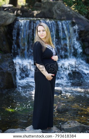 Enjoying Pregnancy, expecting maternity, maternity photography, beautiful young Women Mother Girl outside, warm sunny picture Waterfall Background , Happy Family Concept