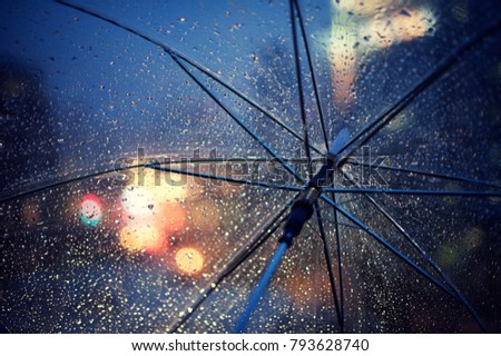 Drops of water in an umbrella on a winter night
