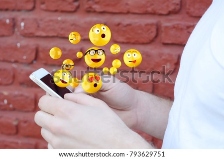 Close-up of man using smartphone sending emojis. Social concept. Royalty-Free Stock Photo #793629751