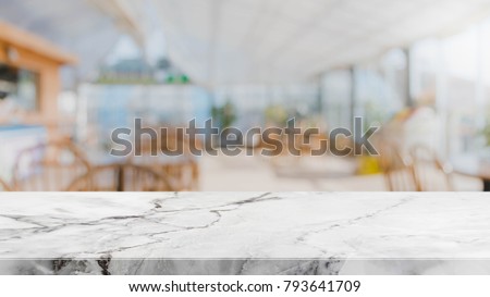 White marble stone table top and blurred restaurant interior background - can used for display or montage your products. Royalty-Free Stock Photo #793641709