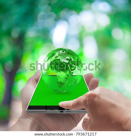 Hand touch screen smart phone and Green earth globe with clipping path Environment concept.Elements of this image are furnished by NASA