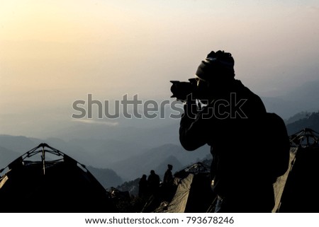 The journey of a man, a photographer and his photos in the morning sunrise.