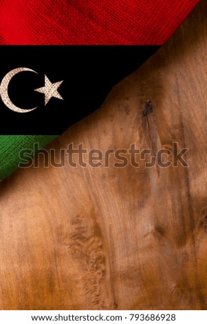 The national flag of Libya on a wooden surface