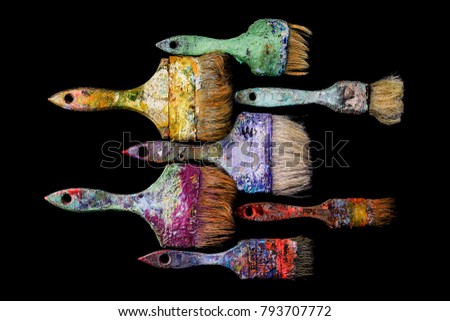 A lot of bright multicolored big old brush yellow purple blue isolated of black background of yellow violet looking like fish