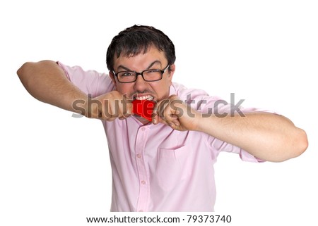 Young man angrily chewing credit card posing isolated on white