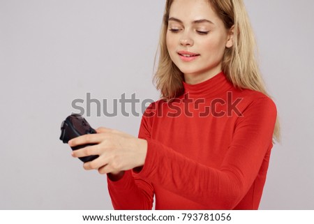  woman with a joystick on a gray background                              