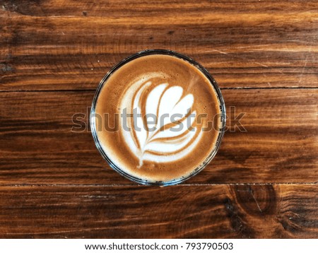 Cup of love , heart latte art coffee in Glass on the vintage wooden table. Love coffee love in your cup. Wake up and full fill energy, top view and center 