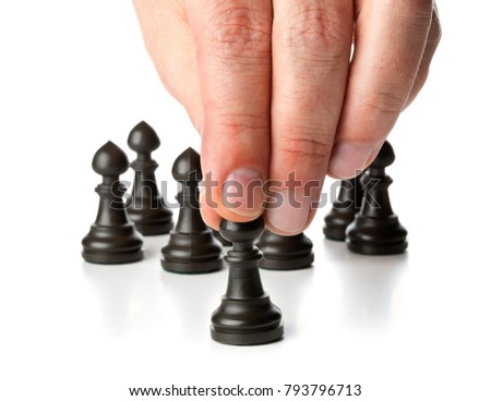 Business man moving chess figure in front of other chess figures - management, leadership, teamlead or strategy concept over white background