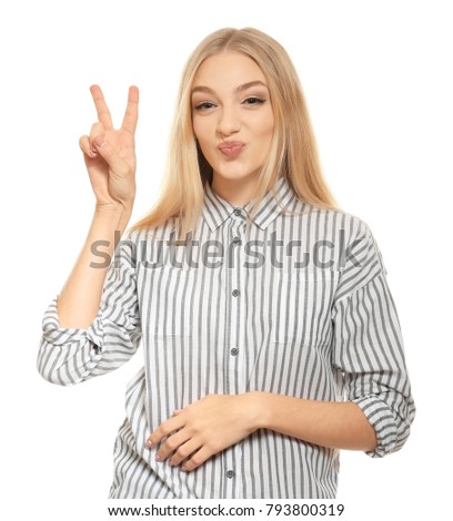 Young funny woman showing victory gesture on white background