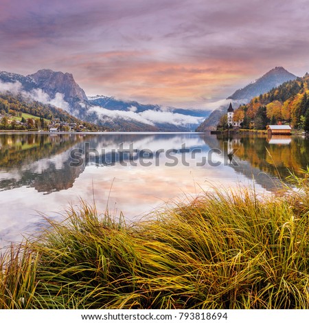 Fantastic Colorful Landscape. View on Fairy-tale lake on Alpine mountains. 
Overcast Paiting sky over the highlands. Grundlsee lake. Picture of wild area,  instagram filter. Creative image