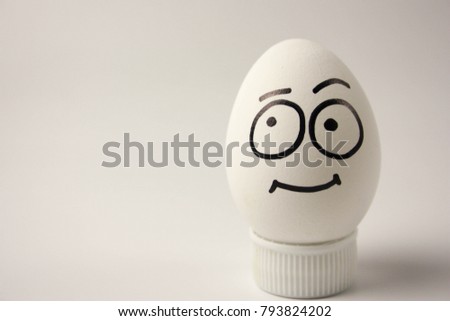 naivety concept. cute and funny egg with painted face and hair. photo for your design Royalty-Free Stock Photo #793824202