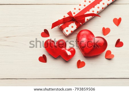 Valentine background with red handmade paper and soap hearts, giftbox on white rustic wooden planks. Happy lovers day card mockup, copy space, top view