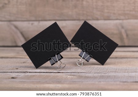 Photo of black business cards. Template isolated on old wood background. For graphic designers presentations and portfolios damaged weathered antique mock-up with black business cards