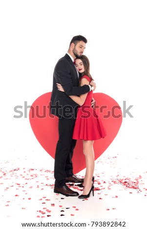 couple hugging near big heart on white, valentines day concept