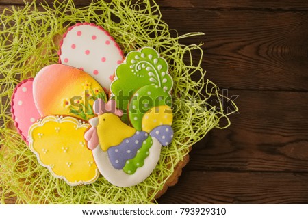 Colorful Easter egg cookies. Wooden background. Top view.