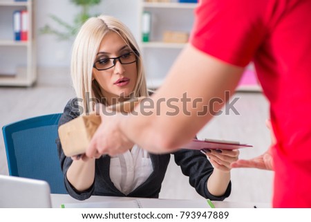 Woman businesswoman receiving mail parcel from courier