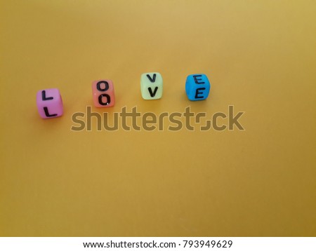 Word "LOVE" are on yellow background for Valentine concept.