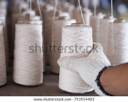 Hands man working in textile threads industry Royalty-Free Stock Photo #793954483