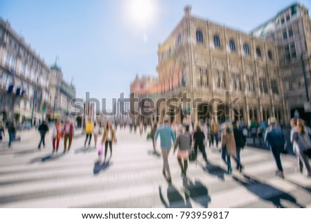 Crowd of anonymous people walking on busy vienna city street