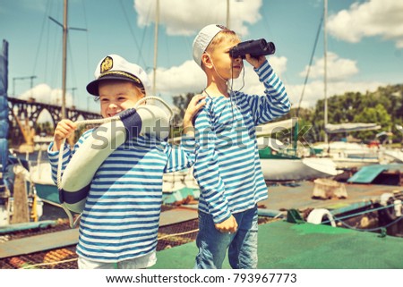 Children on the pier play sailors