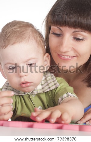 cute mom with her son playing at table