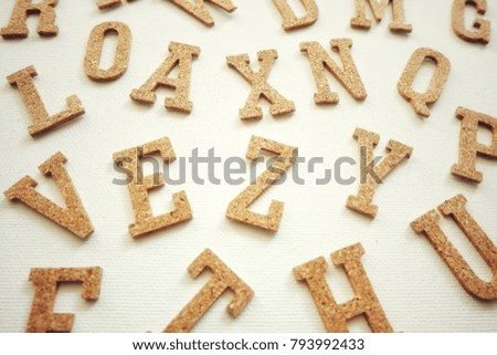 Wooden English alphabet on white background.