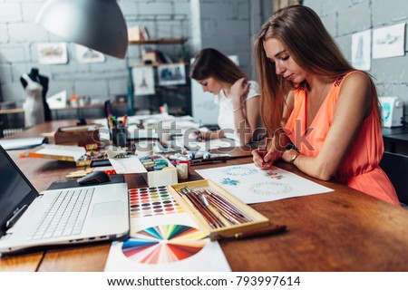 Group of creative fashion designers drawing sketches of accessories working in studio