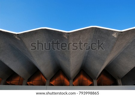 Architecture feature in wave style. Building against beautiful clear blue sky.