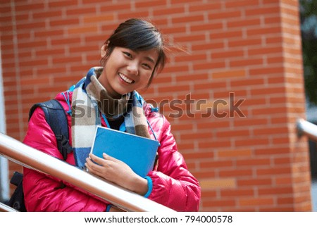 portrait of pretty happy college girl smile at camera