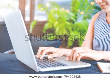 Business woman hand working with a laptop computer in the office.