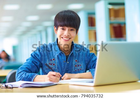 Picture of one young Chinese college student study in the library 