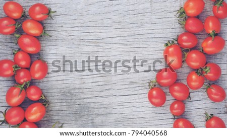Red ripe tomatoes on wood background