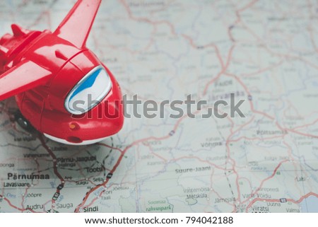 Travel with plane, small toy plain on map background, traveling concept 