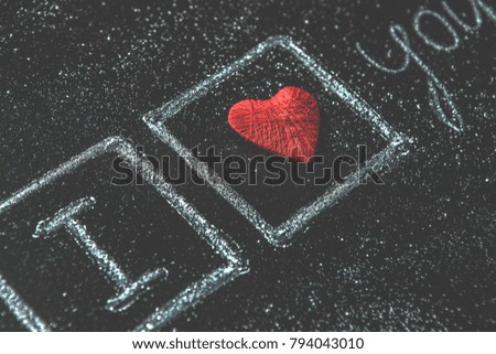 Greeting message i love you with red Heart symbol chalk word on blackboard. Valentine's Day background Wedding greeting card.