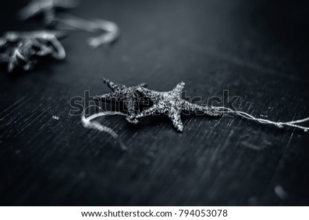 A small star for decoration on a wooden surface.