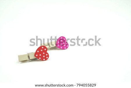 colorful clothespin with heart shape design for valentine concept isolated on white background . Space for text and images .