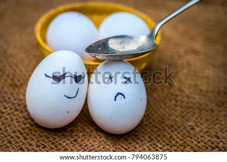 Close up of eggs with an spoon on them.