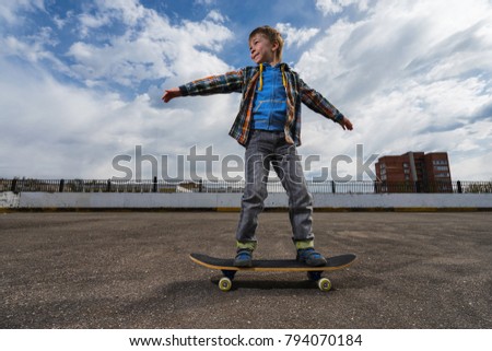 Small boy is going to skateboarding - people, sport and skateboarding concept.