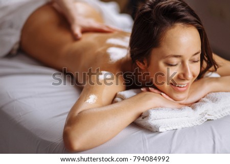Body care. Spa body massage treatment. Woman having massage in the spa salon Royalty-Free Stock Photo #794084992
