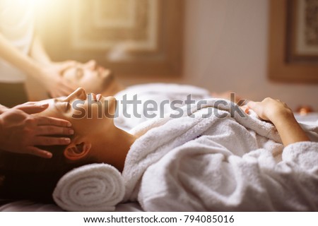 happy young beautiful couple enjoying head massage at the spa Royalty-Free Stock Photo #794085016