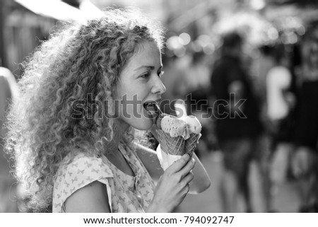 Portrait of beautiful happy smiling emotional young blonde woman with long curly hair eating delicious ice cream  different sorts sunny summer day outdoor in city, horizontal picture
