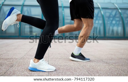 Picture of couple running together in urban area
