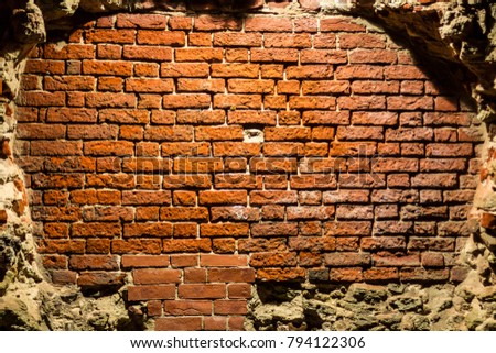 An old brick wall in an abandoned dungeon.